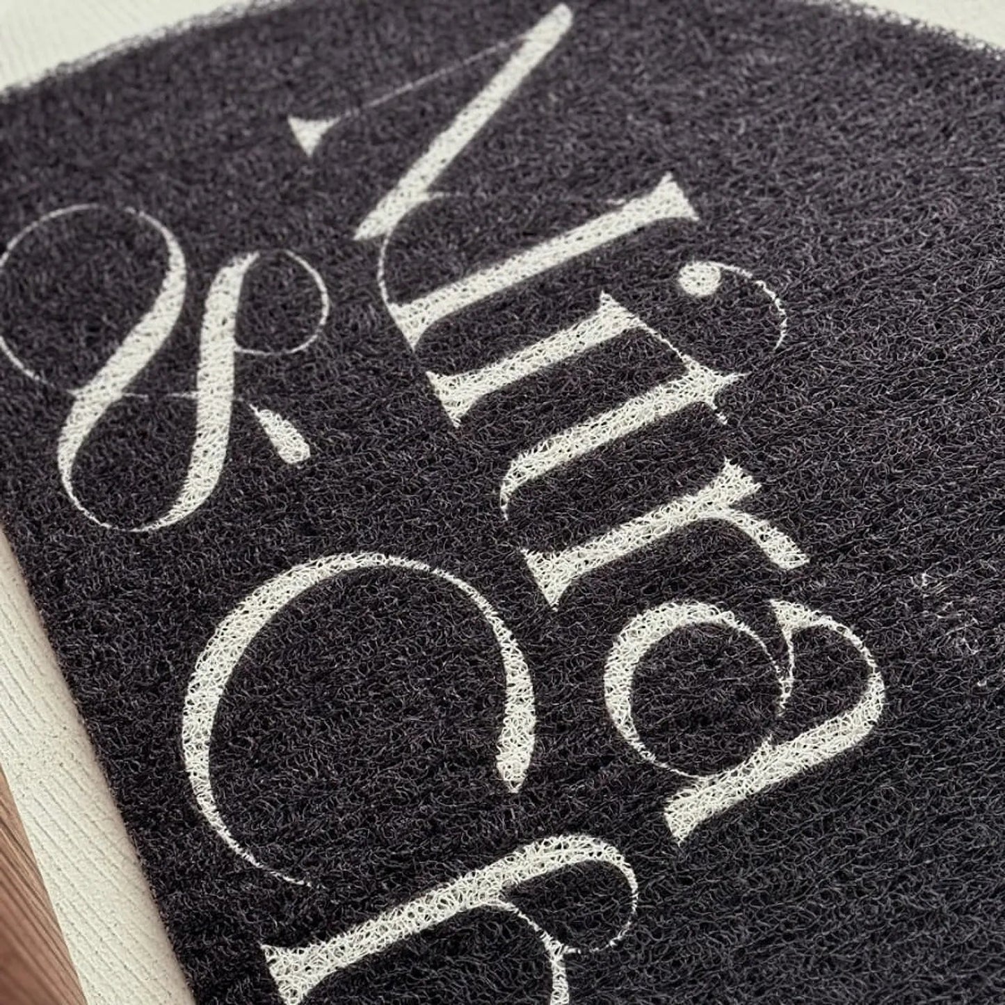 Textured Minimalist Typography PVC Coil Accent Rug
