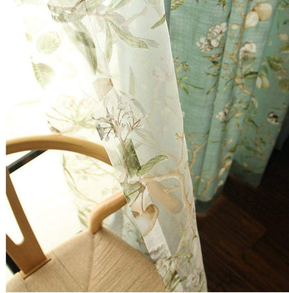 Cortinas opacas azules con estampados florales de pájaros.