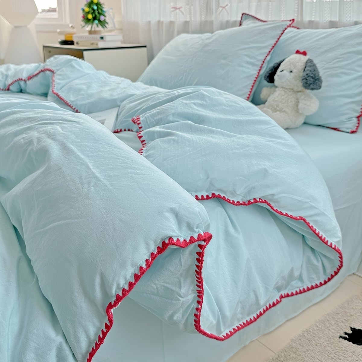 Parure de lit à bords en coquillage et coutures unies